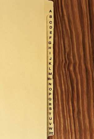 organizer Alphabet tabs on a wood tableの写真素材