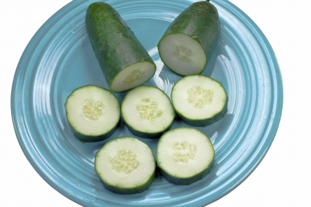 Cucumber slices isolated on a turquoise plate with clipping pathの写真素材