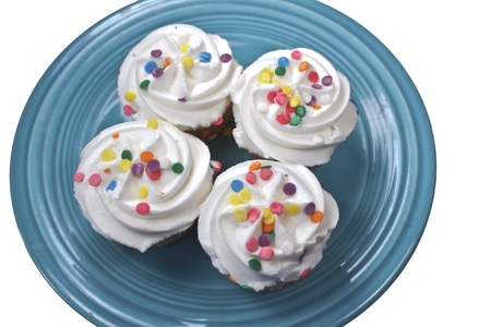 Four cupckes on a turquoise plate isolated on a white backgroundの写真素材