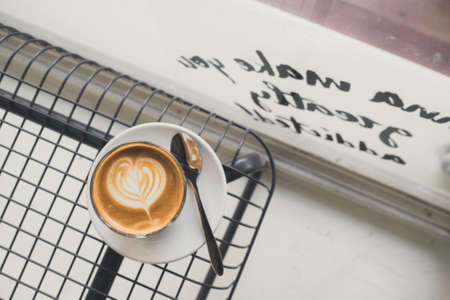 Coffee cup on metal deskの写真素材