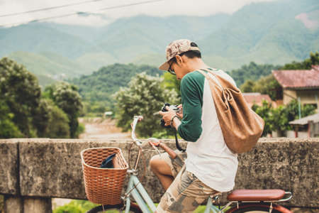 photographer is checking his photo in his camera in country sideの写真素材