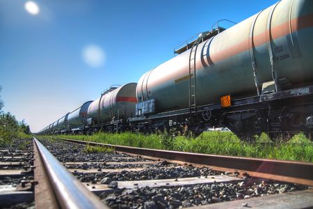 Tanks with fuel being transported by rail, taken in backlitの写真素材