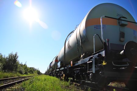 Tanks with fuel being transported by rail, taken in backlitの写真素材