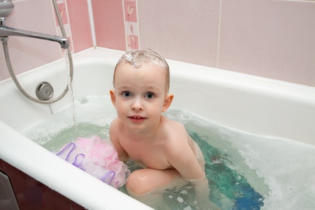 The little boy is washed in the bathroom