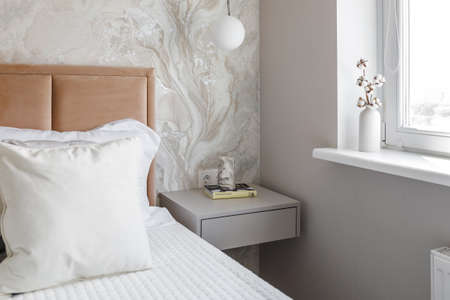 White pillows, duvet and duvet case on a blue bed. White bed linen on a blue sofa. Bedroom with bed...