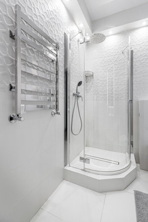 GRODNO, BELARUS -JULY, 2022: bathroom with a shower cabin, a large mirror and a chrome heater or a radiator of a towel against a white wall. Loft style in a new apartment.のeditorial素材