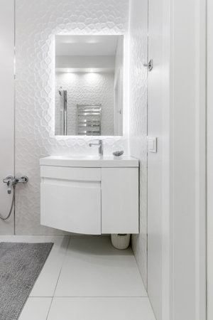 GRODNO, BELARUS -JULY, 2022: bathroom with a shower cabin, a large mirror and a chrome heater or a radiator of a towel against a white wall. Loft style in a new apartment.のeditorial素材