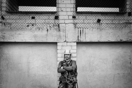 Male worker rope access industrial working at height tank oil wearing harness, helmet safety equipment rope.の写真素材