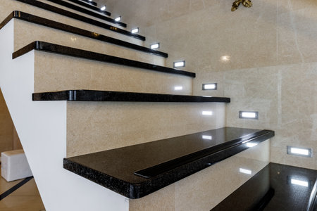 Black staircase made of stone with lighting at night.の写真素材