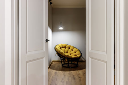 Chrome handle with keyhole on white door with panels in frames. Entrance. Close-up photo of...