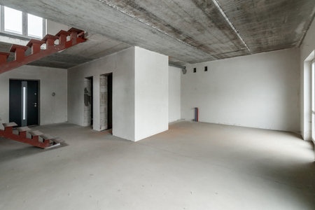 Repairs in the building. Building with a metal staircase at the time of renovation. Construction site in the house without people. Construction of a new house. construction and architecture.の写真素材