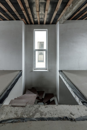 Repairs in the building. Building with a metal staircase at the time of renovation. Construction site in the house without people. Construction of a new house. construction and architecture.の写真素材