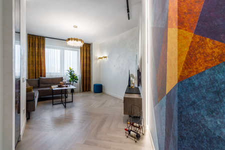 A modern living room interior of a luxurious hotel apartment with a designer couch, and art...