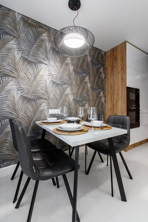 Modern cuisine in black in the dining table and kitchen appliancesの写真素材