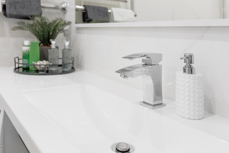 Water faucet mixer located in a modern, bright bathroom. Close-upの写真素材