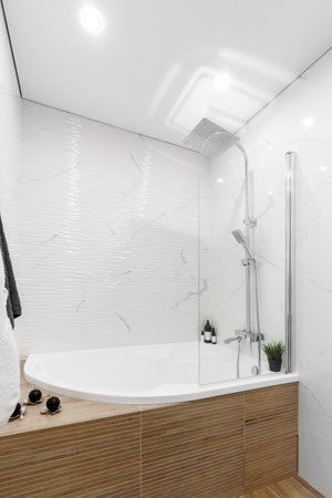 white bathroom and loft shower with monstera and fern flowers.