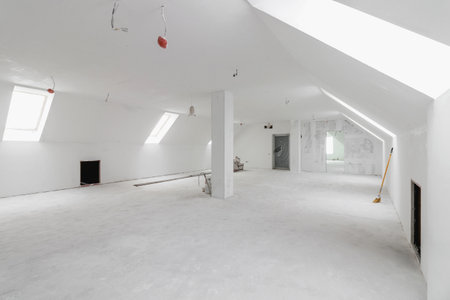 Spacious empty rooms in the attic floor after filling out the work on the wall and ceiling.の写真素材
