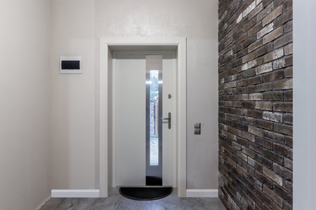 White front door with glass in the center, exit from the house to the yard.の写真素材