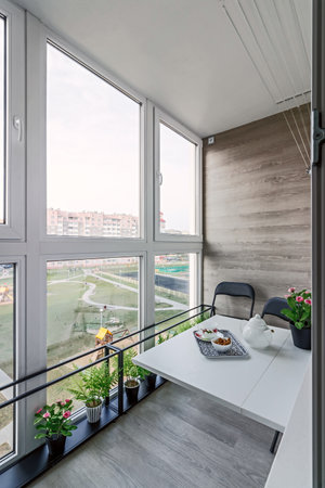 large spacious glazed balcony loggia in the apartment with a gorgeous view of the sunny city.の写真素材