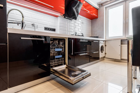 Modern half open empty dishwasher in a modern kitchen.の写真素材