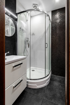 Bathroom with shower cabin, large mirror. Loft style in new apartment. Modern house with contemporary interior.の写真素材