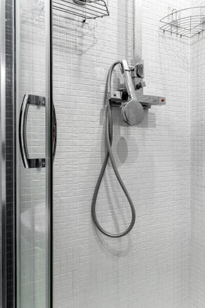 Close up modern glass shower in the white ceramic bath room. Interior of a luxury hotel bathroom with glass shower cabin. transparent shower cabin.の写真素材