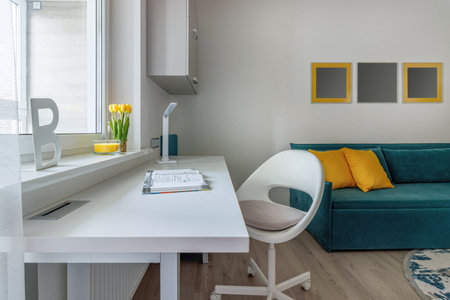 Stylish teenager's room interior with comfortable bed and workplace.