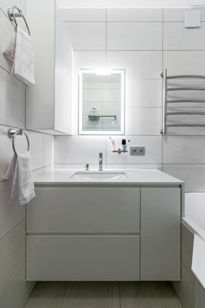 Modern bathroom in white washer and large mirror with backlight.の写真素材