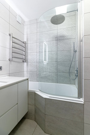 Modern bathroom in white washing and bathroom, and a big shower.の写真素材