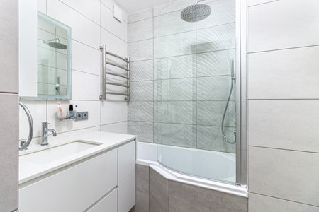 Modern bathroom in white washing and bathroom, and a big shower.の写真素材