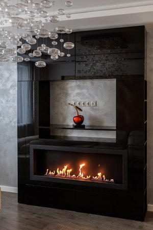 Bio Fireplace burn on ethanol gas. Contemporary mount biofuel on ethanol fireplace. Modern smart ecological alternative technologies. Interior design of a house inside.の写真素材