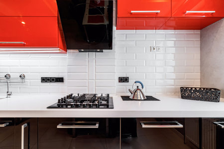 Closeup of modern kitchen interior in white and black tones with, stove and extractor closeup. Cozy place for cooking concept. modern household appliances.の写真素材