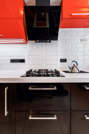 Closeup of modern kitchen interior in white and black tones with, stove and extractor closeup. Cozy place for cooking concept. Modern household appliancesの写真素材
