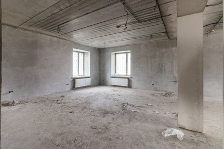 Spacious empty rooms in the attic floor after filling out the work on the wall and ceilingの写真素材