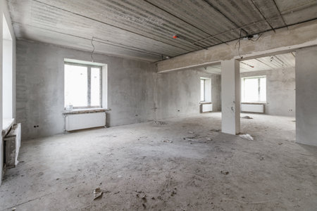 Spacious empty rooms in the attic floor after filling out the work on the wall and ceilingの写真素材