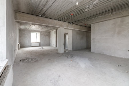 Spacious empty rooms in the attic floor after filling out the work on the wall and ceilingの写真素材