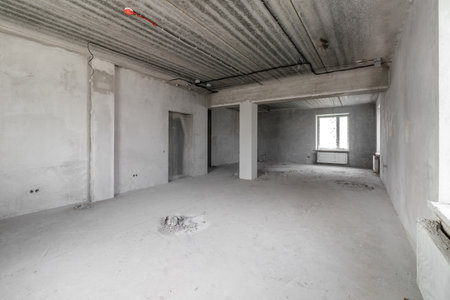 Spacious empty rooms in the attic floor after filling out the work on the wall and ceilingの写真素材