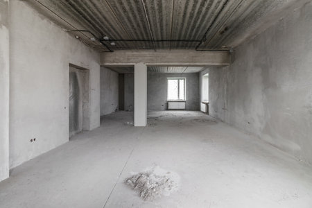 Spacious empty rooms in the attic floor after filling out the work on the wall and ceilingの写真素材
