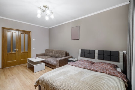 King-size bed in the room with sofa bedside table.の写真素材