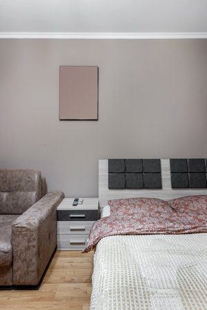 King-size bed in the room with sofa bedside table.の写真素材