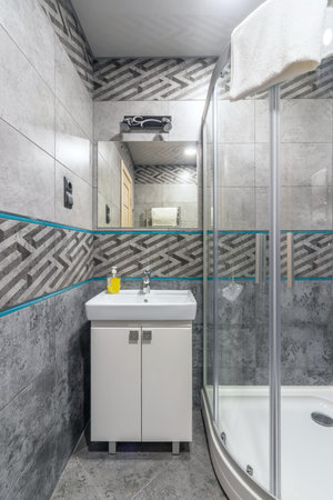 Bathroom in a small family hotel with shower, toilet and sink.の写真素材