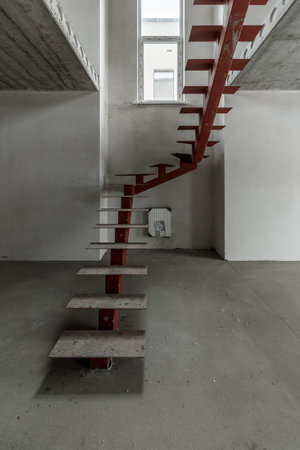Repairs in the building. Building with a metal staircase at the time of renovation. Construction site in the house without people. Construction of a new house. construction and architecture.の写真素材
