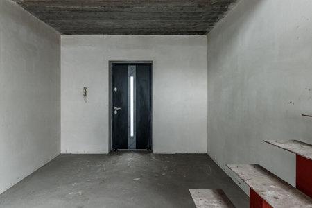Repairs in the building. Building with a metal staircase at the time of renovation. Construction site in the house without people. Construction of a new house. construction and architecture.の写真素材