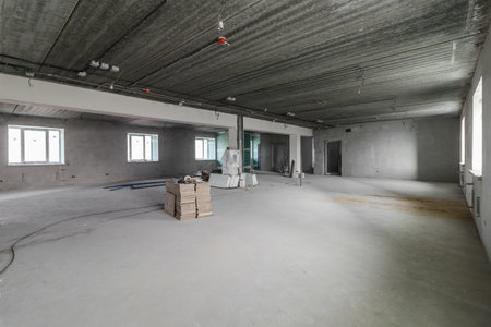 Spacious empty rooms in the attic floor after filling out the work on the wall and ceiling.の写真素材