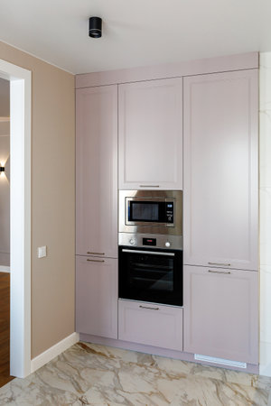 Kitchen furniture in a modern style in a new apartment with a dining tableの写真素材