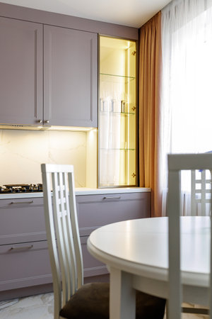 Kitchen furniture in a modern style in a new apartment with a dining tableの写真素材