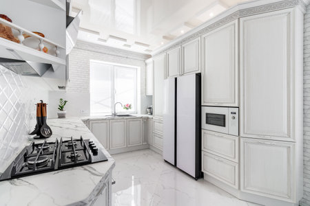 Modern interior with white kitchen and kitchen appliances in the country house.の写真素材