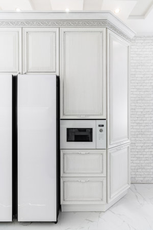Modern interior with white kitchen and kitchen appliances in the country house.の写真素材
