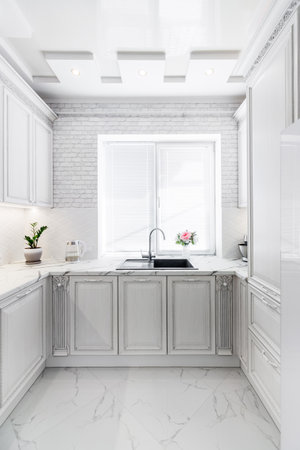 Modern interior with white kitchen and kitchen appliances in the country house.の写真素材
