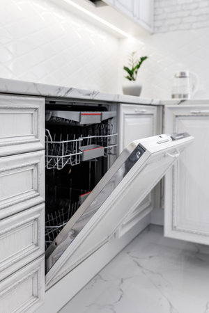 Dishwasher with open door in the modern kitchen photographed close-up.の写真素材